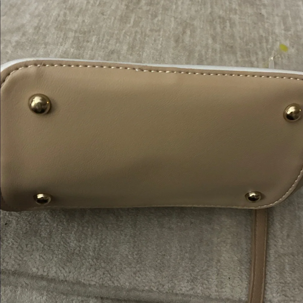 Tan purse‎ with sleek design and smooth finish.